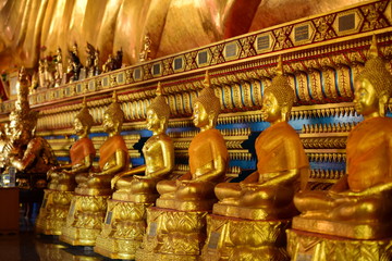 Golden statue of buddha in temple, Thailand