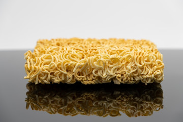 Raw instant noodle ready to cook isolated on black background
