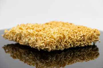 Raw instant noodle ready to cook isolated on black background