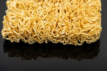 Raw instant noodle ready to cook isolated on black background