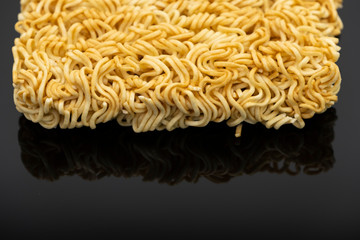 Raw instant noodle ready to cook isolated on black background