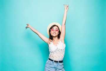 Success asian woman dancing and celebrating standing in full length isolated on green background.