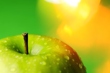 Row of green apples on green background