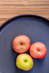 Plate with apples. Autumn layout. Fruit apples. Autumn picture. . Apples and autumn leaves