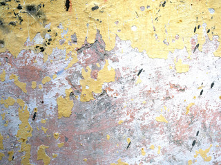 Old cement wall of a building with cracked paint. Aged background and texture