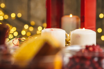 Burning Christmas candle close up on wooden table