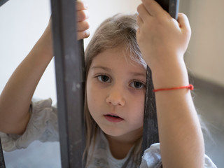 portrait of a disgruntled little blonde girl, child protection concept