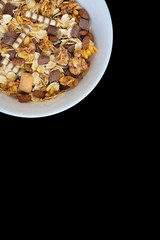 Variety of cold cereals in white bowls, quick breakfast for kids overhead shot with copyspace