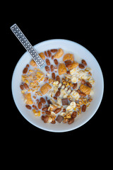 Variety of cold cereals in white bowls, quick breakfast for kids overhead shot with copyspace