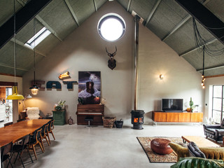 Midcentury modern Scandinavian loft style living room interior. Living room interior with fireplace. Taxidermy deer on wall.