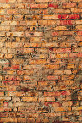 Old weathered brown brick wall for background