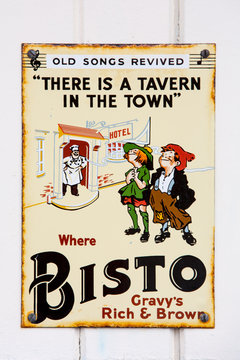 NR SOUTHAMPTON,UK - 25 June 2013: Old style tin advertising board for Bisto gravy browning displayed on painted wood background. On 25 June 2013 Near Southampton UK