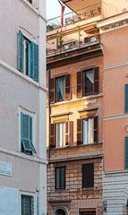 Fototapeta na wymiar Windows on facade of Rome building. Italy