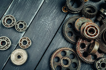 Car parts gears and bearings on wooden background