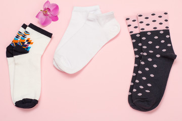 Women socks on pink background. Top view.