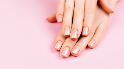 Beautiful Woman Hands. Spa and Manicure concept. Female hands with pink manicure. Soft skin, skincare concept. Beauty nails. over beige background.