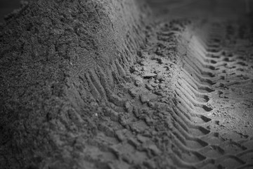Monochrome industrial sand with tire marks