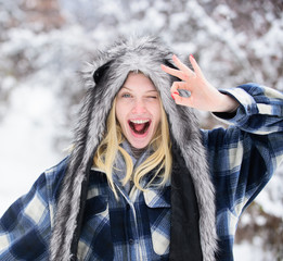 Winking winter girl. Smiling girl showing okay gesture. Fashion girl in wintertime. Winking woman...