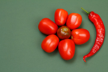 Top view of fresh vegetables on green background.