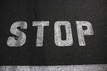 traffic sign - signature STOP on asphalt