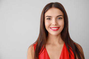 Obraz premium Smiling Young Woman with Red Lipstick Portrait