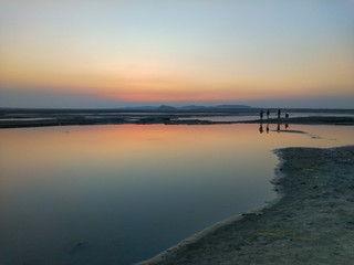sunset on the banks of a river