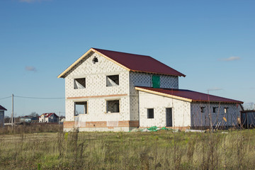 Fototapeta na wymiar Development of land plot. Under construction house of aerated concrete blocks. Russia