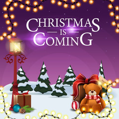 Fototapeta premium Christmas is coming, square purple postcard with cartoon winter landscape, garland, pole vintage lantern and present with Teddy bear