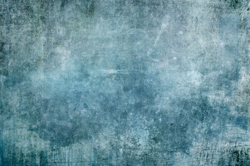 Splattered blue paint on grungy canvas backdrop