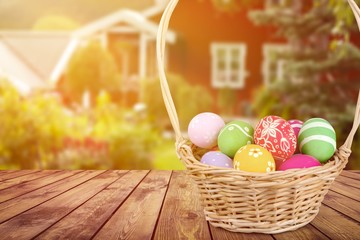 Easter basket filled with colorful eggs on a white background