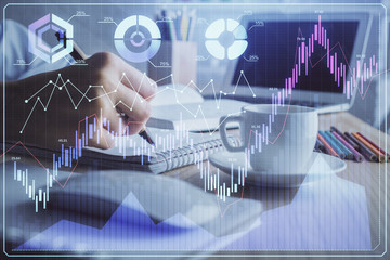 Financial chart drawn over hands taking notes background. Concept of research. Double exposure