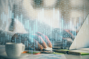 Double exposure of forex graph with man working on computer on background. Concept of market...