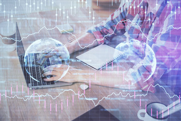 Multi exposure of forex graph with man working on computer on background. Concept of market analysis.