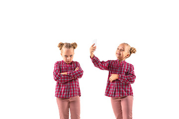Young handsome girl arguing with herself on white studio background. Concept of human emotions,...