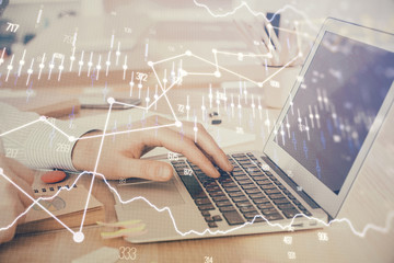 Double exposure of stock market graph with man working on laptop on background. Concept of financial analysis.