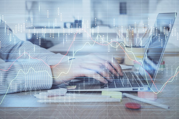 Double exposure of stock market graph with man working on laptop on background. Concept of financial analysis.
