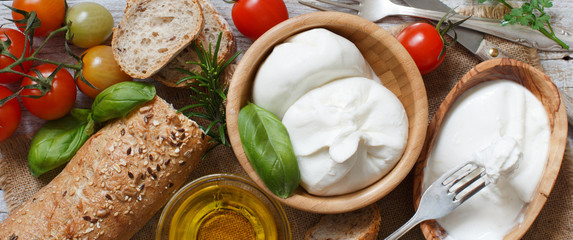Italian cheese burrata with bread, vegetables and herbs