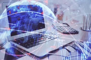 Financial market graph hologram and personal computer on background. Double exposure. Concept of forex.