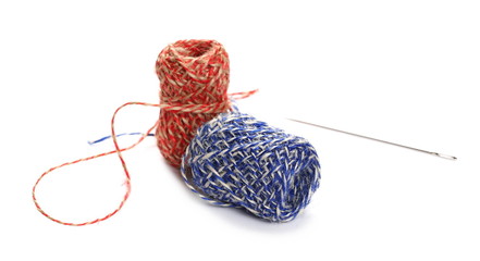 Colorful sewing, knitting yarn strings ball with needle isolated on white background