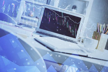 Financial graph colorful drawing and table with computer on background. Multi exposure. Concept of international markets.