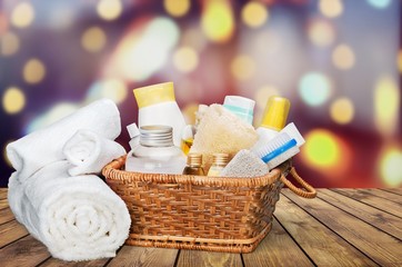 Bath towel and basket with accessories for spa on blur background
