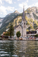 Fototapeta premium Hallstadt, Austria - July 2019: Picturesque old small town Hallstadt is Austrian state of Upper Austria. View from boat.