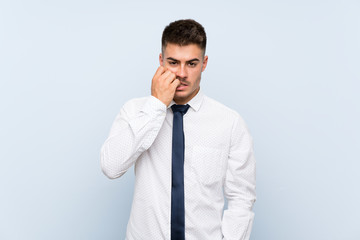 Handsome businessman over isolated blue background nervous and scared