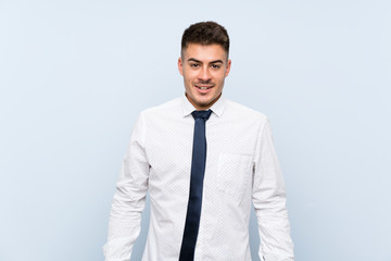 Handsome businessman over isolated blue background with surprise facial expression