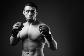 Fototapeta na wymiar Portrait of young muscular Hispanic man as boxer shirtless