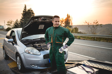 Repairer, transports a broken car on the road.Stock photo