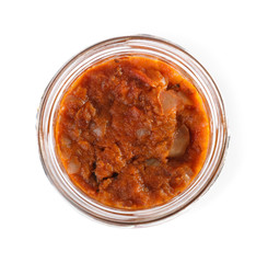 Open jar with vegetable spread on white background, top view. Pickled food