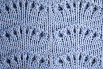 Blue knitted sweater as background, closeup view