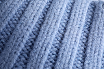 Blue knitted sweater as background, closeup view