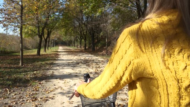 SLOW MOTION Camera revealing the chrome handlebar of city bicycle with unrecognaziable woman ringing the bell